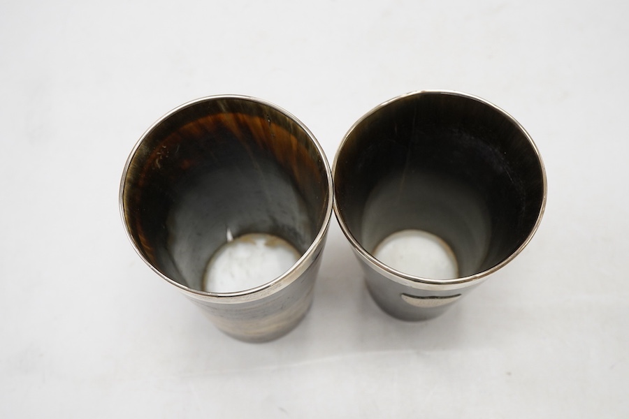 Two Victorian silver mounted horn beakers, by Atkin Brothers, Sheffield, 1882 (split), 14.2cm, and Sheffield, 1884, with shield appliqué, 12.6cm.